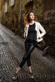 Young attractive woman standing in the wet cobblestone Reber alley of old town of Ljubljana Slovenia
