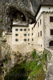 Close up of Predjama Castle 1570 Renaissance fortress built into the mouth of a cliffside cave in Slovenia