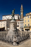 Monument and statue of Giuseppe Tartini at Tartini Square Piran Slovenia with St George's Cathedral and clock bell tower