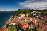 Aerial of Piran Slovenia on Gulf of Trieste Adriatic sea with St Francis of Assisi church bell tower and ancient Town Walls on h