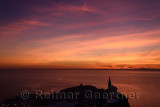 Red sky sunset over the Adriatic Sea at the old city of Piran Slovenia