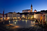 Empty Tartini Square in Piran Slovenia with Courthouse, City Hall, statue, St. George's Parish Church with baptistry, and St Pet