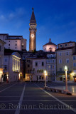 Tartini Square in Piran Slovenia with St George's Parish Catholic Church with belfry tower and baptistry, Venetian House at dusk
