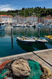 Fishing nets on dock of Piran Slovenia with boats and sailboats moored in harbor on the Adriatic Sea coast