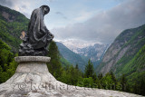 Sculpture of mountaineer Dr Julius Kugy in Trenta Valley with Veliko Spicje peak in Triglav National Park Julian Alps Slovenia