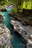 Turquoise water and smoothed karst limestone rocks of Soca river in Spring Trenta Valley Triglav National Park Slovenia at Vrsni
