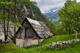 Old Trenta house on Turer farmstead in Trenta Valley with Jalovec mountain in Triglav National Park Julian Alps Slovenia