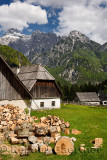 Cut and chopped firewood in high alpine Zadnja Trenta Valley with Traditional Bovec Trenta farmhouse architecture and Razor Peak