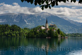 Assumption of Mary pilgrimage church on Bled Island Bled castle on Lake Bled with Vajnez and Veliki Stol Karawanks mountains Ble