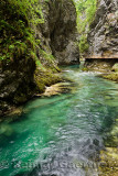 Wood walkway along clear emerald green water of Radovna river at steep narrow Vintgar Gorge Gorenjska region Slovenia
