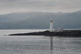 Lismore Lighthouse on Eilean Musdile Islet off Lismore Island on the Firth of Lorn in wet weather with west coast highlands Scot