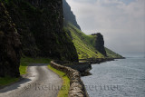 Steep cliffs and rock wall of narrow Highway B8035 on the shore of Loch Na Keal on the Isle of Mull Scotland UK
