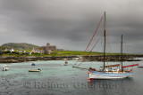 Iona Abbey at Baile Mor village on Isle of Iona in morning cloud with sailboat on Sound of Iona Inner Hebrides Scotland UK