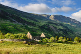 Ruins of St Dubhthach's Church next to Clachan Duich Burial Ground at head of Loch Duich under Beinn Bhreac peak in evening ligh