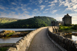 Evening light on new stone arch footbridge to restored Eilean Donan Castle on Island at three lochs in Scottish Highlands Scotla