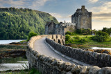 Evening light on restored Eilean Donan Castle on Island at three lochs with added stone arch footbridge Scottish Highlands Scotl