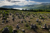 Stone cairns on Highway A87 at Loch Loyne with Spidean Mialach on left and Creag a' Mhaim Highland mountains on right Scotland U