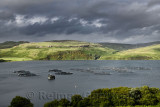Salmon fish farm net pens on Loch Harport with evening sun on Beinn Dhubh from Portnalong Isle of Skye Scotland UK