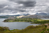 Loch Beag at Ardheslaig between Lochs Torridan and Shieldaig with Meall Ceann Na Creige in sun with dark clouds Scottish Highlan