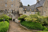 Front of Cawdor Castle with drawbridge bell and Stags Head Buckel Be Mindfull emblem in the rain Cawdor Nairn Scotland UK