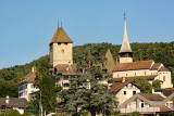 Old part of the city of Spiez with the castle and the old church, seen from the boat after departing from Spiez
