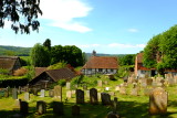 St.Bartholomews churchyard  surrounded by houses on adjacent  street.