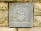Brick in the cemetery wall depicting different regiments