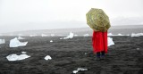 Tourist with icebergs at Diamond Beach, by Jökulsárlón glacial lagoon, Iceland 805