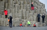 Tourists and Column Basalts at Reynisfjara is a world-famous black-sand beach, Vik, Iceland 1690