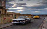 1959 Chevrolet Impala and Mercury convertible parked near Malceon