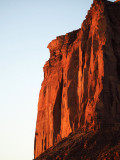 The just risen sun lights up the cliff face at Monument Valley
