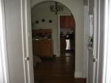 Walking down the entry hall towards the diningroom and kitchen.