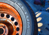 Washed up car wheel at Langland Bay.