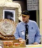 Trophies, memories, and a uniform with badges.     And fruit for sale.
