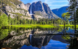 Yosemite Falls reflected in the flooded Merced River in Yosemite National Park