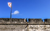 Spanish flag and cannons on top of the San Agustin Bastion in Castillo de San Marcos National Monument 