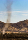 A swirling dust devil moves across the scorched grasslands of Buenos Aires NWR