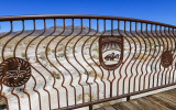 The refuge, with mountains in the distance, through a railing in Ash Meadows NWR 