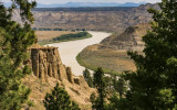 The Missouri River snakes its way past a rock formation as viewed from the Lower Two Calf Road in Upper Missouri River Breaks NM