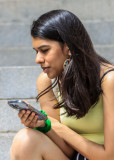 New York City fan checks her cell phone in New York City