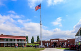 Fifteen-star flag flies over the parade ground in Fort McHenry NM and HS