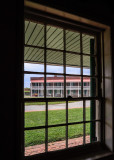 Enlisted Mens Barracks as seen through a guardhouse window in Fort McHenry NM and HS