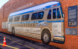 Greyhound bus mural in the station driveway where the racist mob first attacked the bus in Freedom Riders National Monument