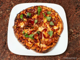 The Carnivore: hot Italian sausage, pepperoni, bacon and a side salad of basil leaves