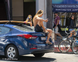 Surfer eating on car Downtown HB 8-11-19 (1) CC S2 w.jpg