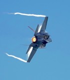The F-35 with afterburner kicked in and weapons bays open.  The white on the topside is a partial Vapour Cone.