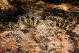Palm prints on soot covered ceiling - likely from cowboys seeking shelter