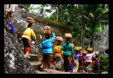 The offerings consist of fruits, rice cakes and flowers and are carried on womens heads to the temple