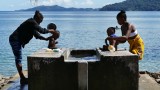 Women bathing their kids in Ampangorinana