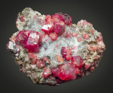 Pink grossular (crystals to 2 cm) from Sierra de Cruces, Coahuila, Mexico. 8 x 7 x 5 cm
